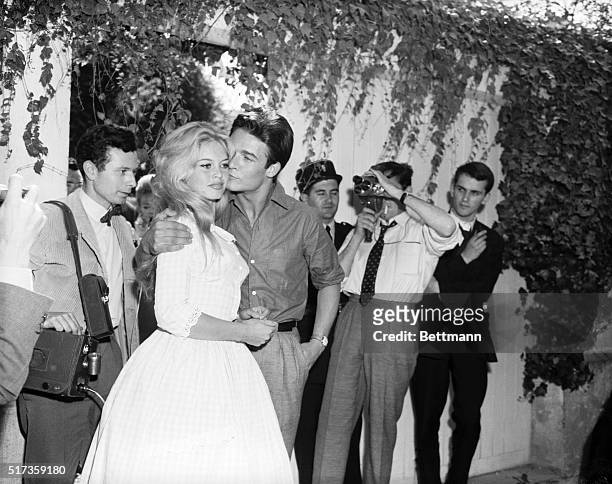 Louveciennes, France- French movie actress Brigitte Bardot gets a kiss from her new husband, actor Jacques Charrier, in the garden of her parents'...