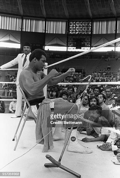 Kuala Lumpur, Malaysia- World heavyweight champ Muhammad Ali takes a break from a workout in the National Stadium to address spectators. He tells the...