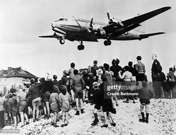 Berlin, Germany-The Berlin airlift brings supplies to the blockaded city of 2 1/2 million West Berliners. Children eagerly wait for plane.