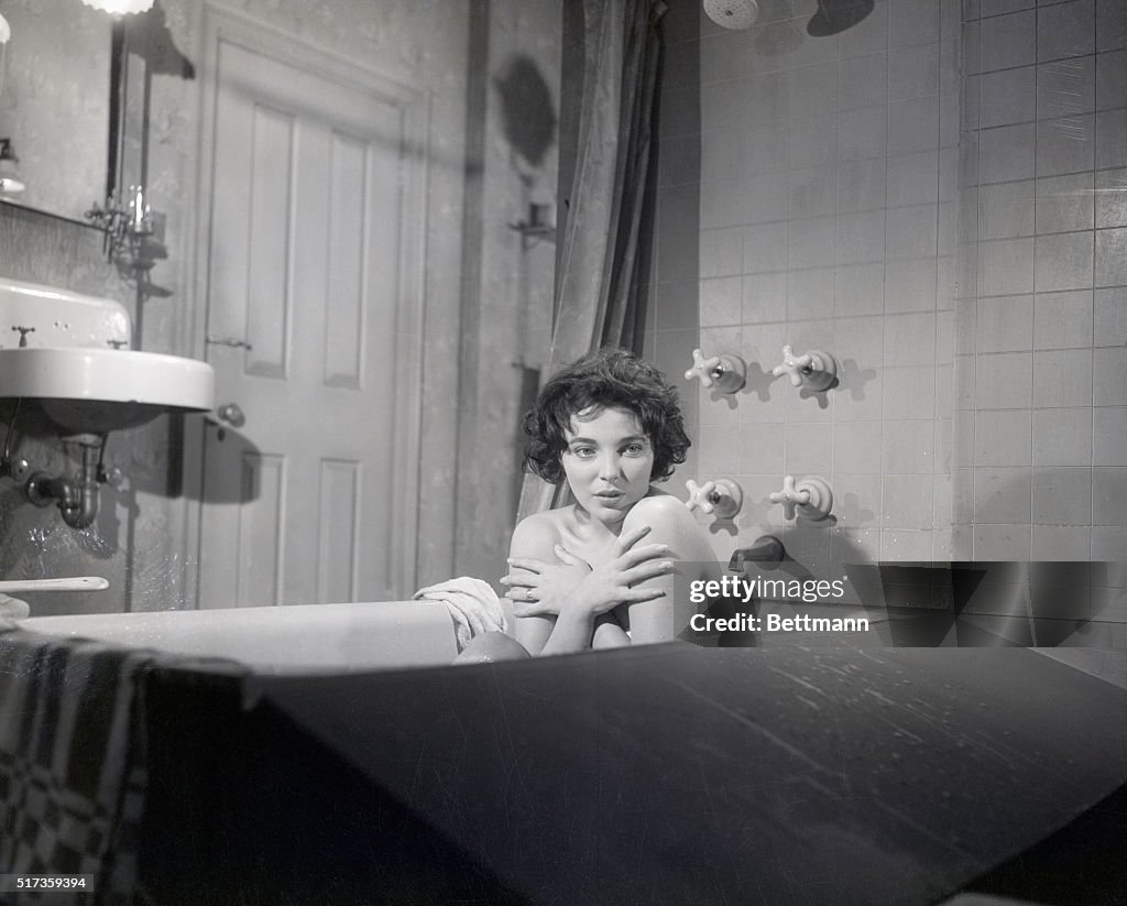 Joan Collins Covering Chest in Bathtub