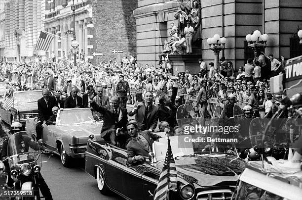 New York, NY-Apollo 11 astronauts Buzz Aldrin, Michael Collins and Neil Armstrong wave to crowds lining the streets during a ticker-tape parade for...