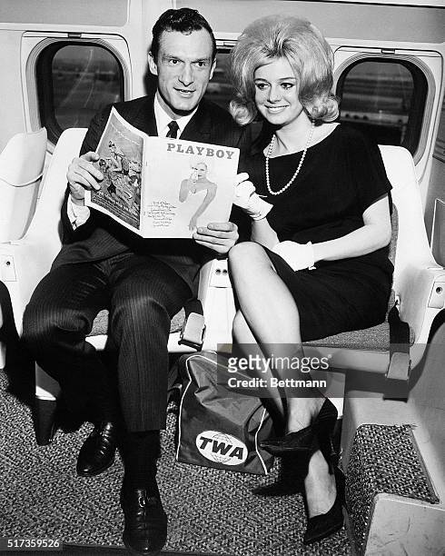 New York,NY -: Hugh M. Hefner, Editor and Publisher of Playboy, is shown with Cynthia Maddox, the blond cover girl on the February issue of his...