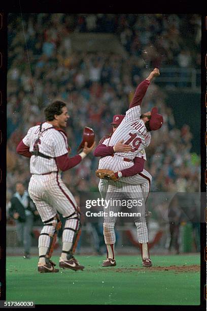 Last game of playoffs won by Phillies. After last out all players rush toward the pitchers mound. Pitcher Al Holland jumps on Mike Schmidt. Catcher...