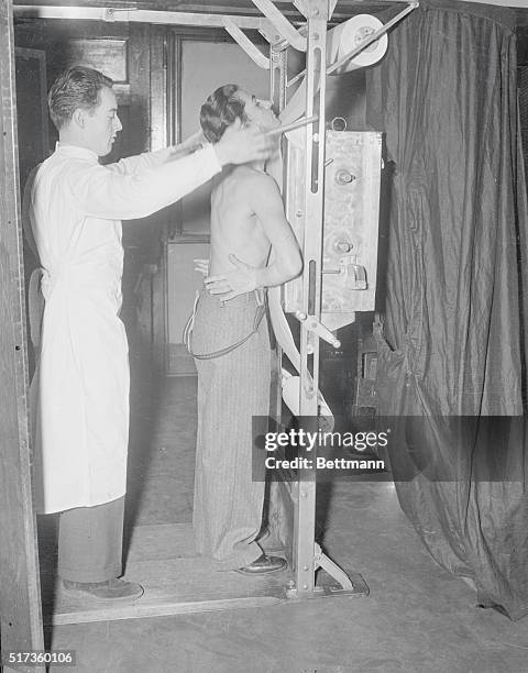 New York: Line Forms On The Left. Students wait their turn to be x-rayed at Stuyvesant High School, as Board of Education Medical Examiners peep at...