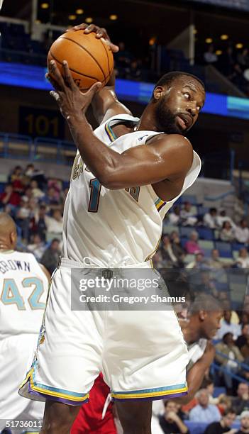 Baron Davis of the New Orleans Hornets grabs a rebound against the Atlanta Hawks at the New Orleans Arena November 12, 2004 in New Orleans,...