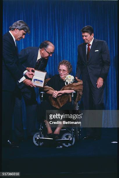 President Reagan presents Medal of Freedom to performer Kate Smith. Charlie Gaddy, Senator Jesse Helms of North Carolina, Kate Smith and President...