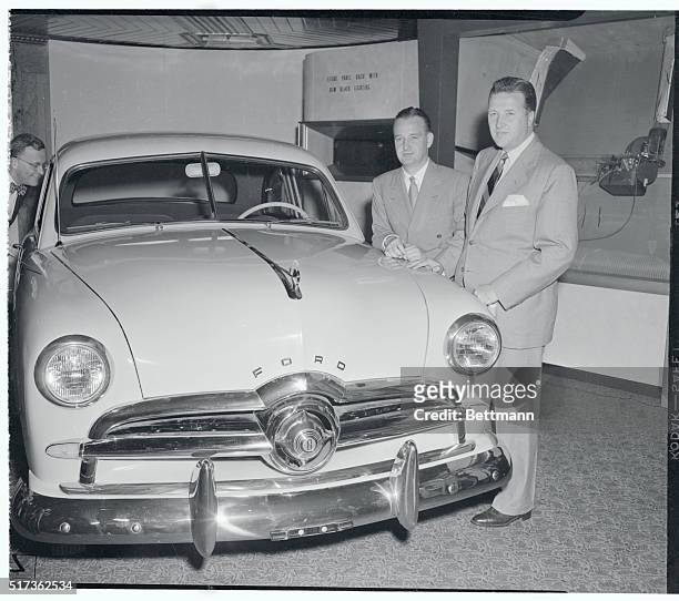World premiere of 1949 Ford...Henry Ford II , president of Ford Motor Company, and his brother, Benson, a company vice president, stand beside a new...
