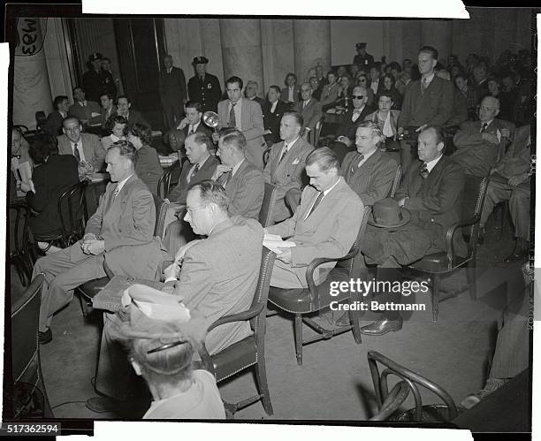 Millionaire plane maker Howard Hughes sits with his witnesses at the Senate War Investigating Hearing probing his wartime contracts. In the 1st row,...