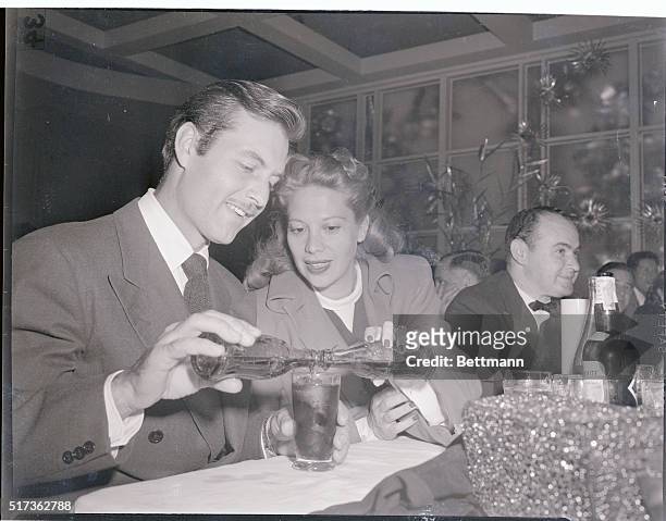 Hollywood, CA.: Hollywood Newsreel. It may be a new way to mix soft drinks, but actor George Montgomery and his wife Dinah Shore seemed enthusiastic...