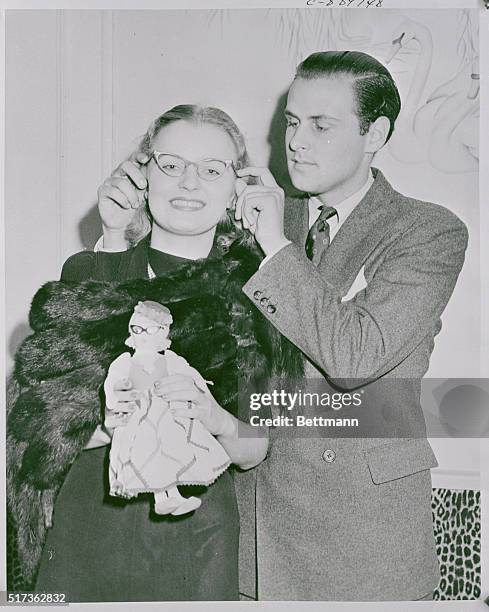 She's Got "Specs Appeal." New York: June Hawkridge, a prominent member of the young Mayfair set, is shown having her eyeglasses adjusted by Billy...