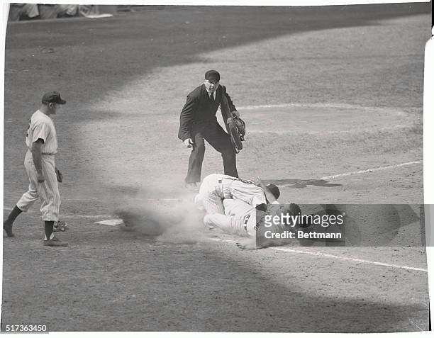 Taking the throw from Gil McDougald, Yank catcher Yogi Berra tags the sliding Bob Avila of Cleveland in the sixth inning of the July 26th game....