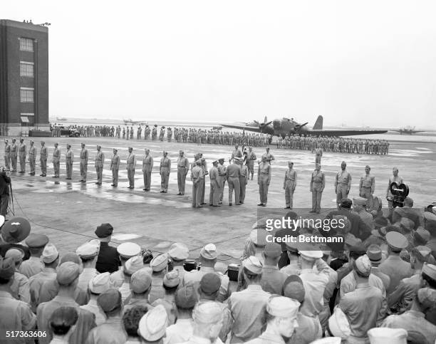 Generl Henry H. Arnold, Commander of the Army Air Forces is shown as he passed down the line of 27 fliers who participated in the raid on Tokyo,...