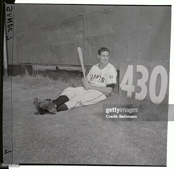 Bobby Thomson whose pennant winning clout made him a hero last year, relaxes here at the 430 foot sign on the Giant's spring training grounds at...