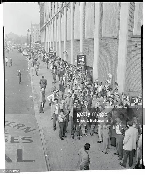 Brooklyn's Ebbets Field is besieged by determined ball fans who line up early to get tickets for the crucial National League playoff opener between...