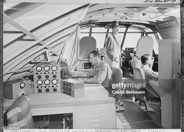 American aircraft designer, Howard Hughes with crew on the flight deck of his strategic airlift flying boat, the Hughes H-4 Hercules at Terminal...