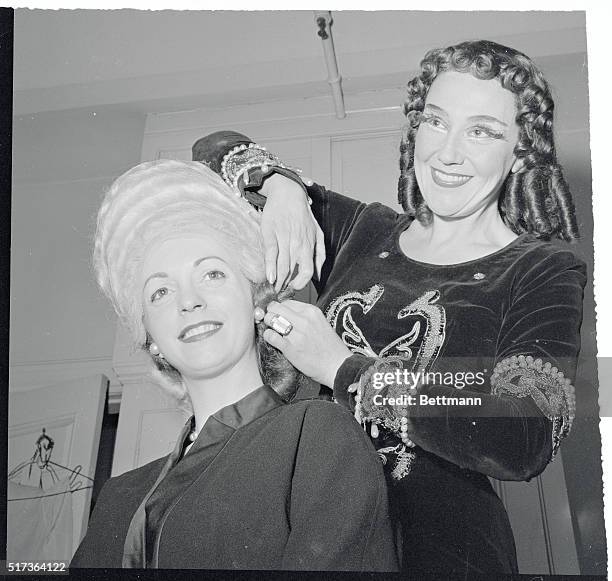 Backstage at the Metropolitan Opera House, Blanche Thebom, dressed for her role as Herodias in the new production of the opera Salome, works on the...