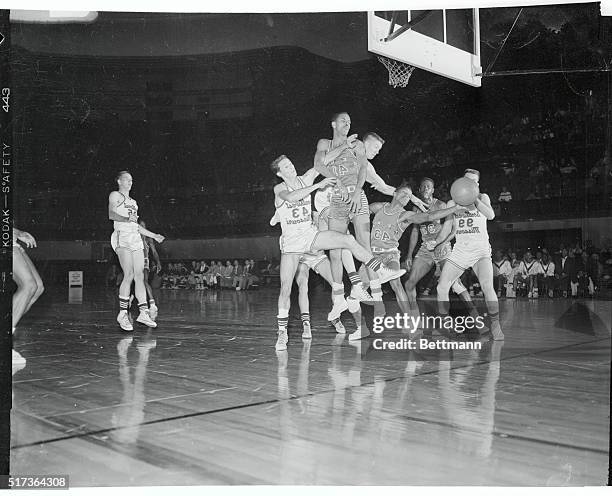 There's a mad scramble for a rebound during the opening minutes of the starting game of the NAIA Basketball Tourney at Kansas City, Mo. Tennessee A &...