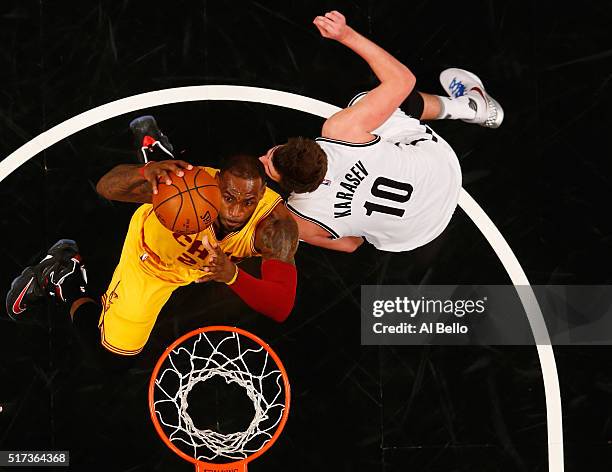 LeBron James of the Cleveland Cavaliers dunks against Sergey Karasev of the Brooklyn Nets during their game at the Barclays Center on March 24, 2016...