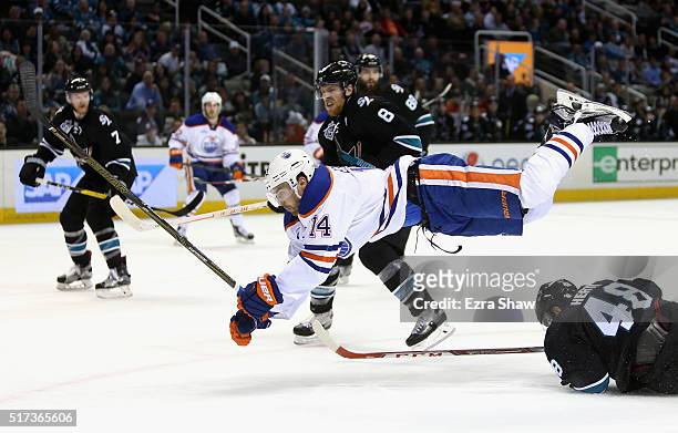 Jordan Eberle of the Edmonton Oilers goes airborne after hitting Tomas Hertl of the San Jose Sharks at SAP Center on March 24, 2016 in San Jose,...