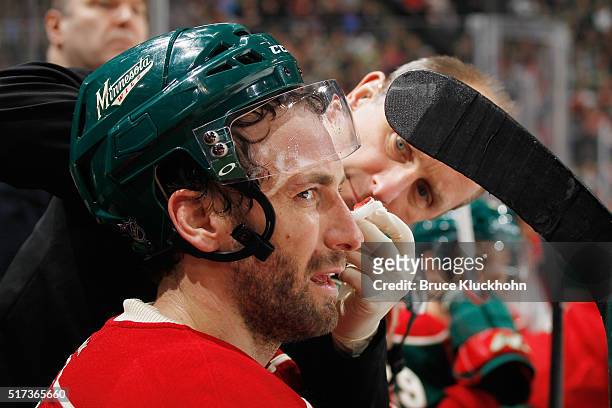 Jarret Stoll of the Minnesota Wild is treated by a trainer during the game against the Calgary Flames March 24, 2016 at the Xcel Energy Center in St....