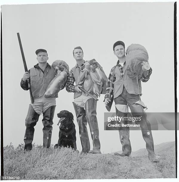 This star studded duck hunting team pauses to survey the terrain, trying to find a good location. Left to right are: Aldo Ray; Robert Francis; and...