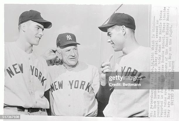 New York Yankees Manager Casey Stengel seems puzzled as he tries to tell who's who during a discussion with Ray and Roy Mantle, twin brothers of...