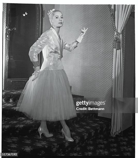 Castillo of Lanvin sets a pale pink-and-silver lame jacket over a dance dress of paler pink silk net. The jacket, modeled after a tuxedo, has...