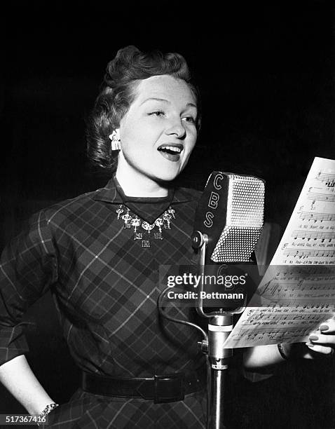 Vocalist Jo Stafford sings the nation's top tune favorites and introduces leading musical artists on her new CBS radio program the Jo Stafford Show...