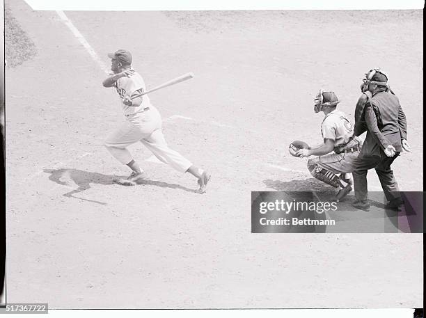 Don Newcombe of thr Brooklyn Dodgers is shown here batting and scoring on a home run.