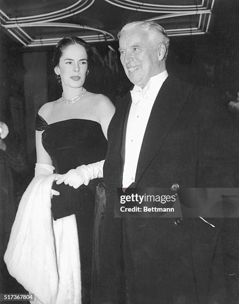 Chaplins at Royal Film Show. London, England: Screen comedian Charlie Chaplin and his wife, Oona O'Neill, arriving for the Royal Film Performance...