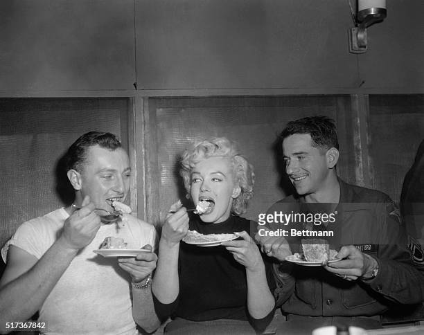 American actress Marilyn Monroe tries some cake in the Enlisted Men’s Mess Hall at Headquarters Company, 2nd Infantry Division, near Seoul, South...