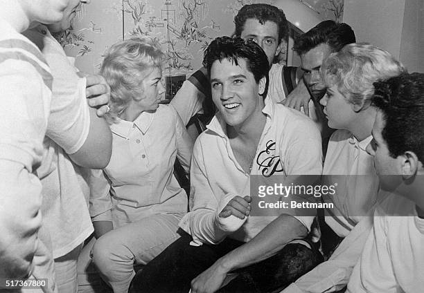 Rock n' Roll singer Elvis Presley relaxes in a hospital room with Anita Wood and a group of friends here, October 17th, after being treated for a...