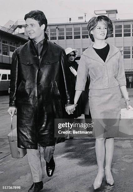 Hand in hand, French actress Brigitte Bardot and her husband, actor Jacques Charrier, arrive at Orly airport to plane for Lisbon, Portugal. On March...