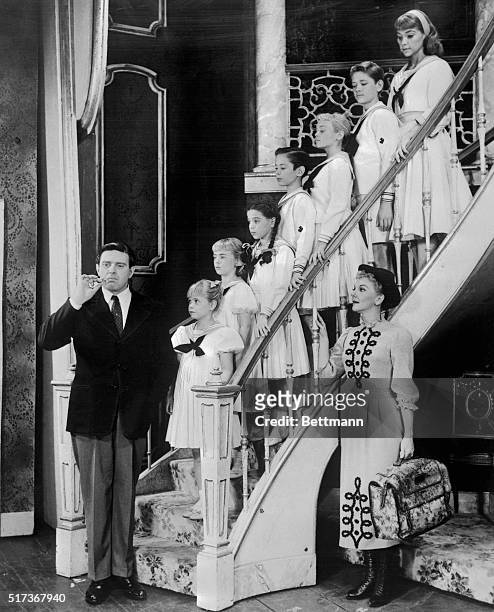 Mary Martin and Theodore Bikel are shown with the seven youngsters who play their children at the Lunt-Fontaine Theater on Broadway. The stars and...