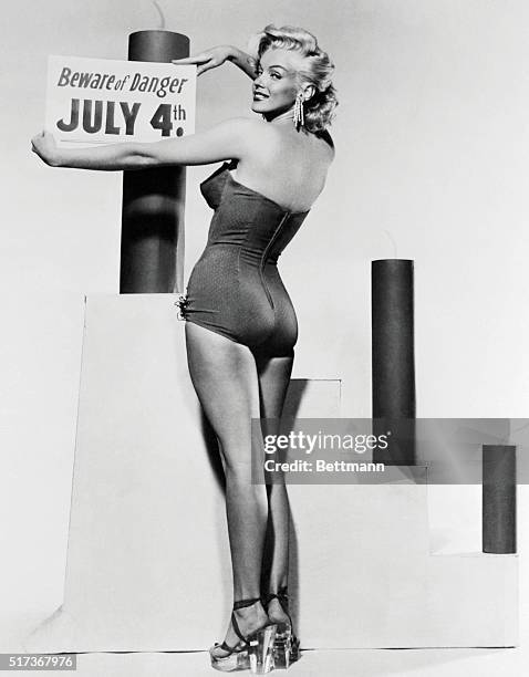 Hollywood's sizzling blonde bombshell, Marilyn Monroe, advises to "Beware of Danger" while celebrating on the Fourth of July.