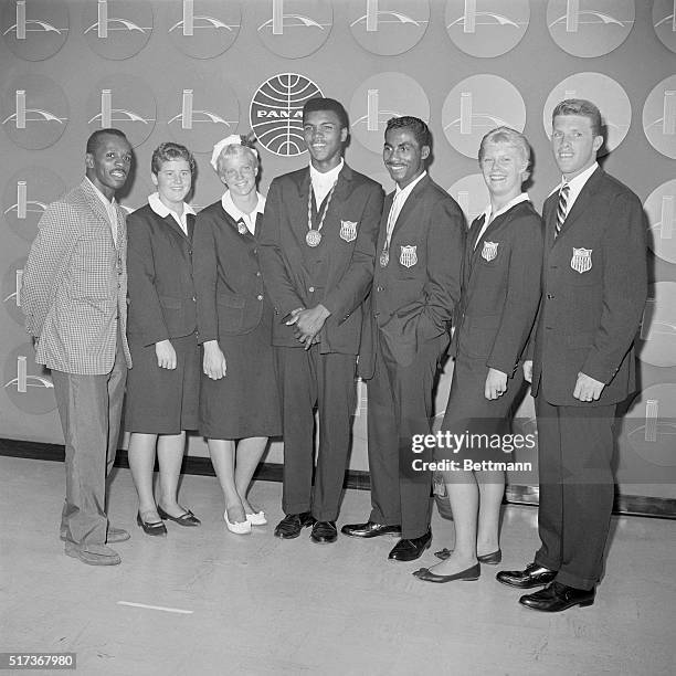 Seven American Olympians who earned gold medals at Rome arrive at New York's Idlewild Airport, September 8th. Left to right are: Sgt. Eddie Cook,...