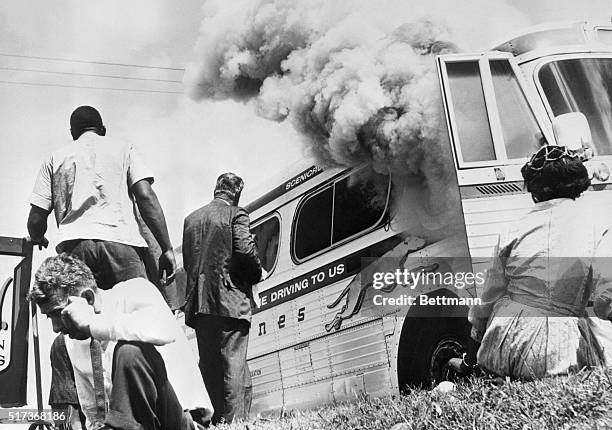 Passengers of this smoking Greyhound bus, some of the members of the "Freedom Riders," a group sponsored by the Congress of Racial Equality , sit on...