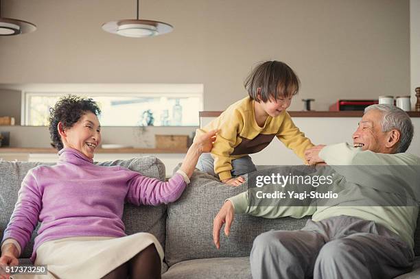 grandparent and grandson have fun in the living room - grandmas living room stockfoto's en -beelden