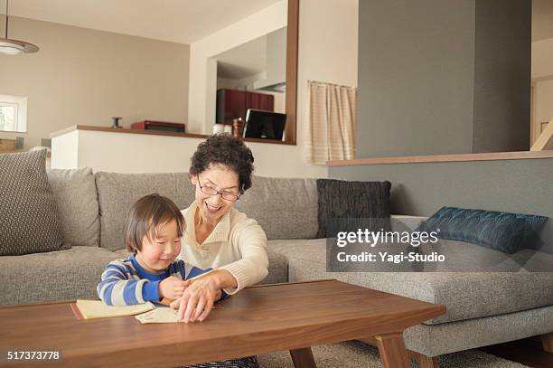 grandmother and grandson have fun in the living room - grandmas living room stock pictures, royalty-free photos & images