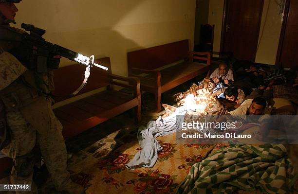Marines from the 1st U.S. Marines Expeditionary Force, 1st Battalion, 3rd Marines Regiment, Bravo Company, find Iraqi men as they search a house...
