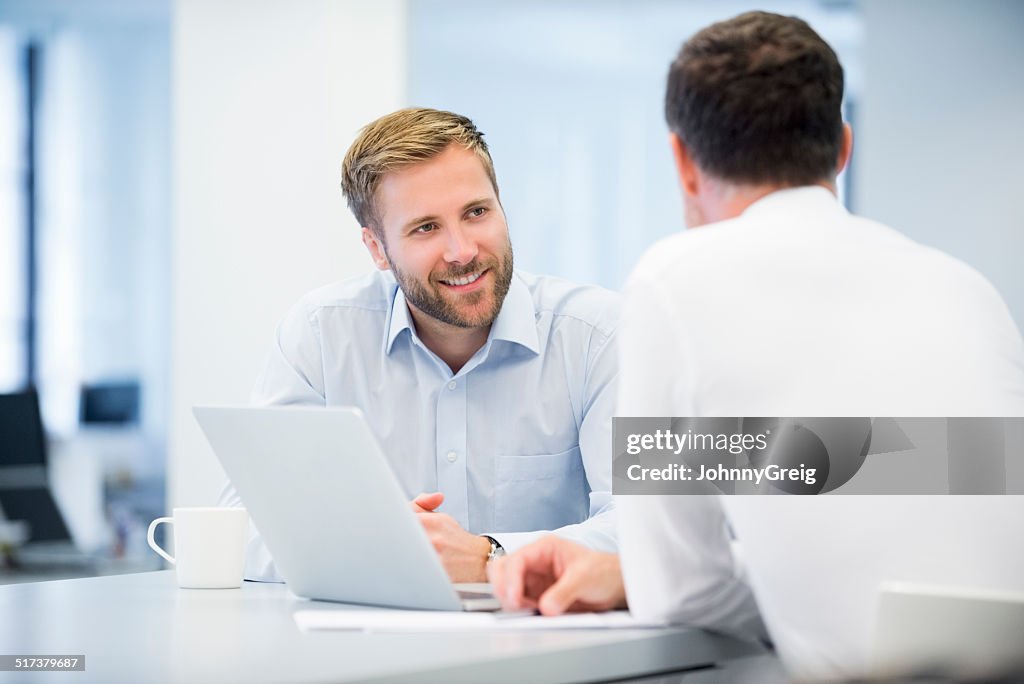 Businessman Discussing With Male Colleague