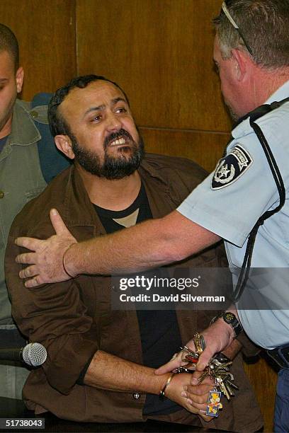 Senior Palestinian activist Marwan Barghouti is restrained by an Israeli policeman as he exchanges verbal insults with bereaved Israelis January 2,...