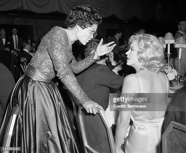 Stage star Eartha Kitt is shown here chatting with Marilyn Monroe at the Milk Fund dinner.