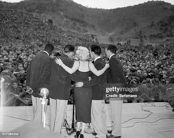 Marilyn Monroe performing for 45th Division in Korea. Marilyn Monroe wearing a skintight purple dress, appeared today before more than 10,000 Marines...