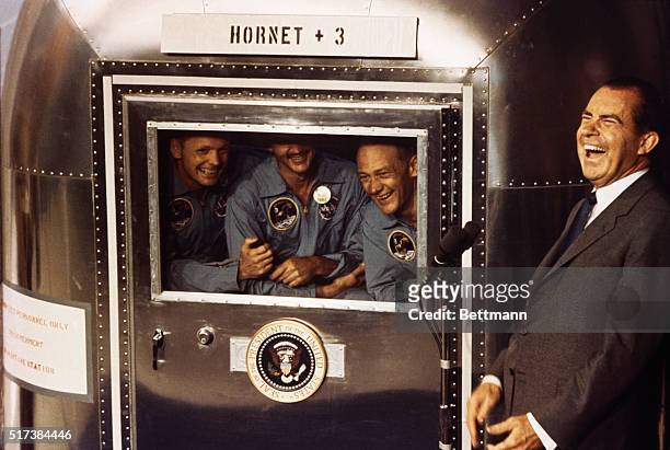 Aboard the USS Hornet: A happy President Richard M. Nixon laughs with Apollo 11 astronauts, left to right, Neil A. Armstrong, Michael Collins, and...