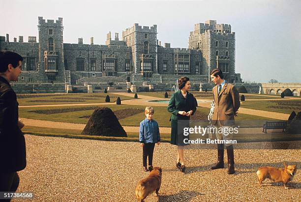 Prince Charles, Queen Elizabeth, and Prince Edward are shown here on the lawn of their Windsor home.