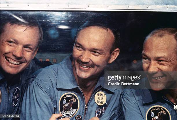 Apollo 11 astronauts : Neil Armstrong, Michael Collins and Buzz Aldrin peer from window of their isolation quarters aboard the U.S.S. Hornet after...
