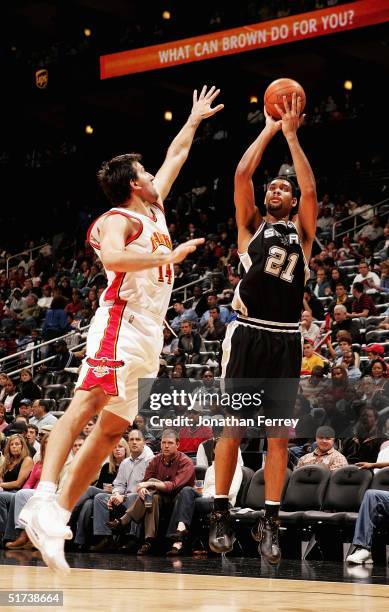 Tim Duncan of the San Antonio Spurs shoots over Pedrag Drobnjak of the Atlanta Hawks on November 13, 2004 at Philips Arena in Atlanta, Georgia. NOTE...