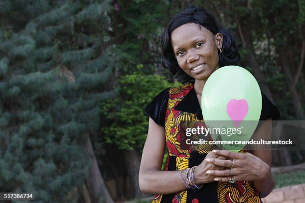 the woman with a green ballon - black balloon stock-fotos und bilder