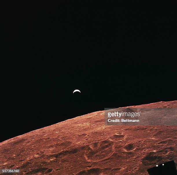 Space Center, Houston: Earthrise over lunar horizon as viewed from command module during Apollo 12 flight. The lunar surface, as viewed from orbit,...
